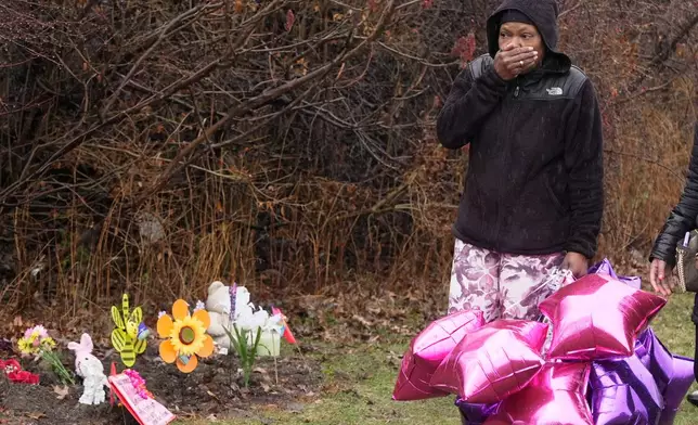 Nichelle Wilson, the grandmother of one of the girls whose bodies were found earlier this week, Amor Wilson, holds her hand to her face as she arrives at the memorials at that site, in Cleveland, Thursday, March 5, 2026. (AP Photo/Sue Ogrocki)
