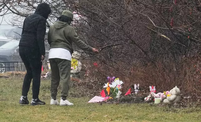 People visit a memorial at the site where two girls bodies were found earlier this week, in Cleveland, Thursday, March 5, 2026. (AP Photo/Sue Ogrocki)