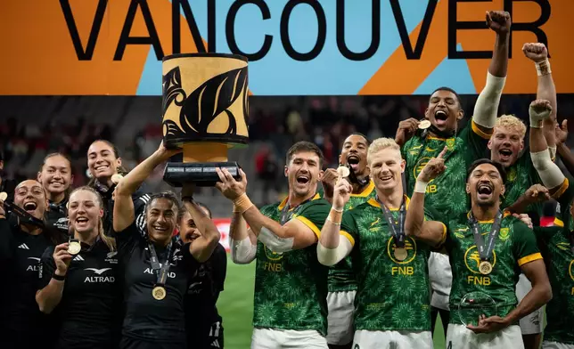 New Zealand team, left, and South Africa's team lift the Champion's Cup during the gold medal Vancouver Sevens rugby match, in Vancouver, British Columbia, Sunday, March 8, 2026. (Ethan Cairns/The Canadian Press via AP)