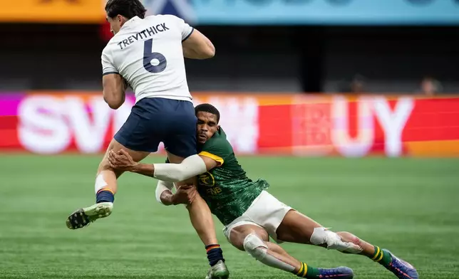 South Africa's Sebastiaan Jobb (16) tackles Spain's Jeremy Trevithick (6) during a gold medal Vancouver Sevens rugby match, in Vancouver, British Columbia, Sunday, March 8, 2026. (Ethan Cairns/The Canadian Press via AP)