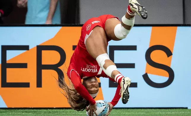 Canada's Charity Williams (6) scores a try against Fiji during Vancouver Sevens women's rugby action, in Vancouver, on Sunday, March 8, 2026. (Ethan Cairns/The Canadian Press via AP)