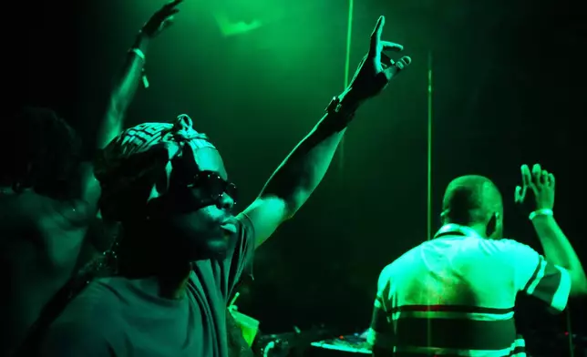 People dance to house music during a Group Therapy rave in Lekki, an upscale part of Lagos, Nigeria, early Saturday, Feb. 28, 2026. (AP Photo/Sunday Alamba)