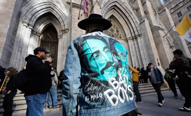A man wears a jacket with an image of Willie Colon during Colon's funeral at St. Patrick's Cathedral in New York, Monday, March 9, 2026. (AP Photo/Seth Wenig)