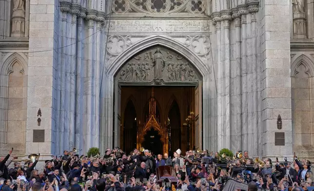 Musicians, primarily trombonists, play music as the body of Willie Colon leaves St. Patrick's Church in New York, Monday, March 9, 2026. (AP Photo/Seth Wenig)