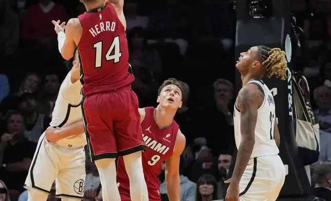 Miami Heat guard Tyler Herro (14) shoots during the first half of an NBA basketball game against the Brooklyn Nets, Thursday, March 5, 2026, in Miami. (AP Photo/Lynne Sladky)