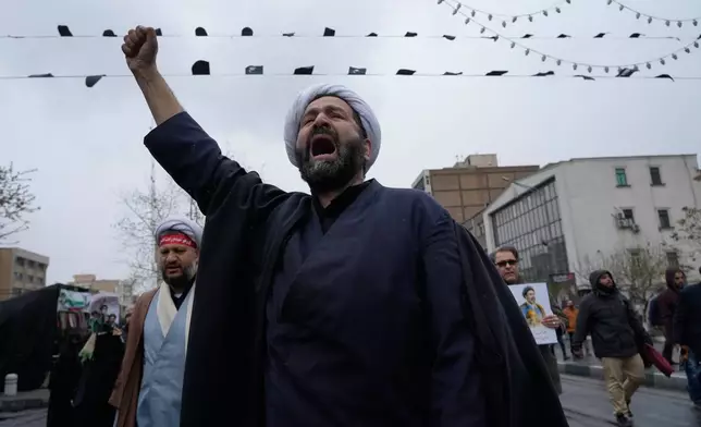 A cleric chants slogans during the annual anti-Israeli Quds Day, or Jerusalem Day rally in support of Palestinians in Tehran, Iran, Friday, March 13, 2026. (AP Photo/Vahid Salemi)