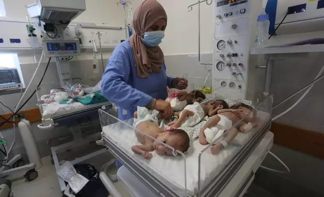 FILE - A nurse cares for prematurely born Palestinian babies that were brought from Shifa Hospital in Gaza City to the hospital in Rafah, Gaza Strip, Sunday, Nov. 19, 2023. (AP Photo/Hatem Ali, File)