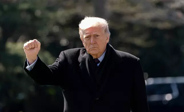 President Donald Trump pumps his fist as he walks to depart on Marine One from the South Lawn of the White House, Wednesday, March 18, 2026, in Washington. (AP Photo/Alex Brandon)