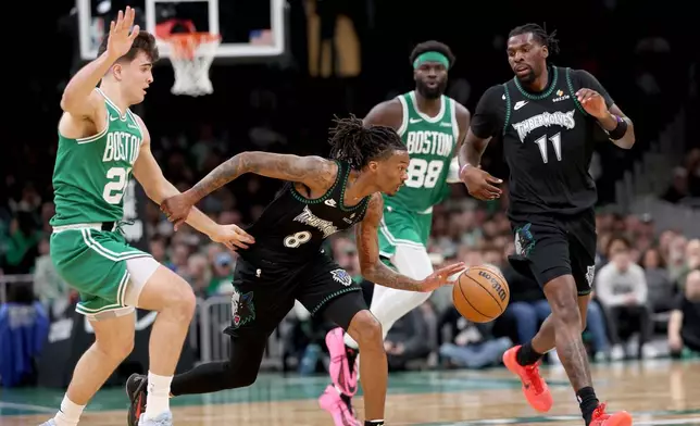Minnesota Timberwolves guard Bones Hyland (8) dribbles the ball past Boston Celtics forward Hugo González (28) during the first half of an NBA basketball game, Sunday, March 22, 2026, in Boston. (AP Photo/Mark Stockwell)