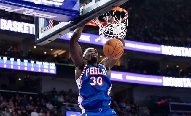 Philadelphia 76ers center Adem Bona dunks during the first half of an NBA basketball game against the Utah Jazz, Saturday, March 21, 2026, in Salt Lake City. (AP Photo/Anna Fuder)