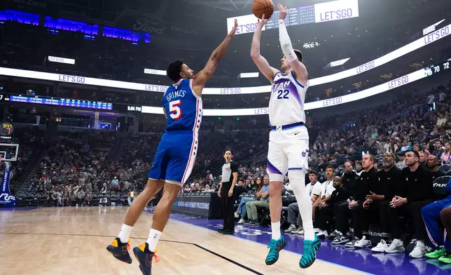 Philadelphia 76ers guard Quentin Grimes (5) defends against Utah Jazz center Kyle Filipowski (22) as he shoots a three during the second half of an NBA basketball game, Saturday, March 21, 2026, in Salt Lake City. (AP Photo/Anna Fuder)
