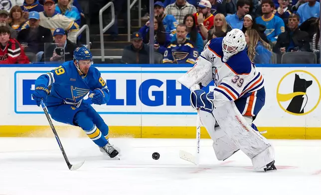 Edmonton Oilers goaltender Connor Ingram (39) clears the puck in front of St. Louis Blues' Pavel Buchnevich (89) during the second period of an NHL hockey game Friday, March 13, 2026, in St. Louis. (AP Photo/Scott Kane)
