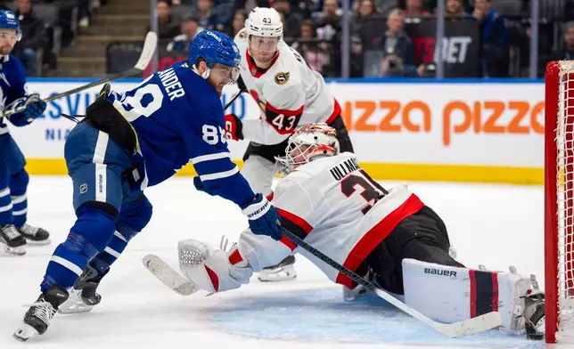 Toronto Maple Leafs right wing William Nylander (88) scores on Ottawa Senators goaltender Linus Ullmark (35) as defenseman Tyler Kleven (43) looks on during the second period of an NHL hockey game in Toronto, Saturday, Feb 28, 2026. (Frank Gunn/The Canadian Press via AP)