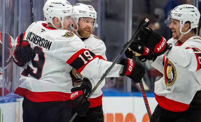 Ottawa Senators right wing Drake Batherson (19) is congratulated by right winger Claude Giroux (28) and defenseman Thomas Chabot (72) after scoring during the second period of an NHL hockey game in Toronto, Saturday, Feb 28, 2026. (Frank Gunn/The Canadian Press via AP)