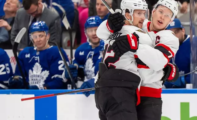 Ottawa Senators defenseman Thomas Chabot (72) celebrates after his goal with teammate Brady Tkachuk (7) during first-period NHL hockey game action against the Toronto Maple Leafs in Toronto, Saturday, Feb 28, 2026. (Frank Gunn/The Canadian Press via AP)