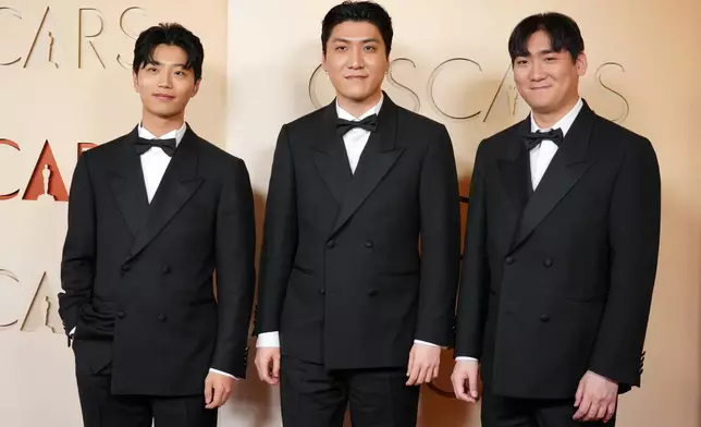 Yu Han Lee, from left, Zhun, and Hee Dong Nam arrive at the Oscars on Sunday, March 15, 2026, at the Dolby Theatre in Los Angeles. (Photo by Jordan Strauss/Invision/AP)