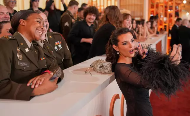 Bella Thorne poses with fans as she arrives at the Oscars on Sunday, March 15, 2026, at the Dolby Theatre in Los Angeles. (AP Photo/John Locher)