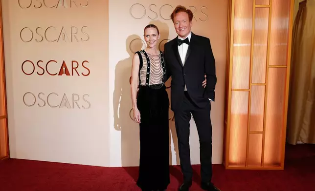 Liza Powel O'Brien, left, and Conan O'Brien arrive at the Oscars on Sunday, March 15, 2026, at the Dolby Theatre in Los Angeles. (Photo by Jordan Strauss/Invision/AP)