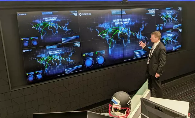 FILE - The CEO of FireEye Kevin Mandia gives a tour of the cybersecurity company's unused office space in Reston, Va., March 9, 2021. (AP Photo/Nathan Ellgren, file)