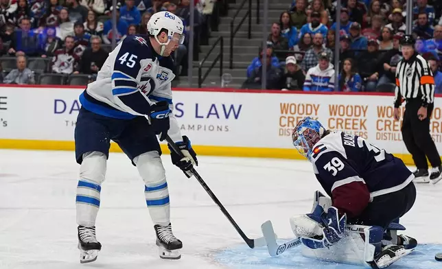 Winnipeg Jets left wing Cole Koepke, left, scores against Colorado Avalanche goaltender MacKenzie Blackwood (39) in the second period of an NHL hockey game Saturday, March 28, 2026, in Denver. (AP Photo/David Zalubowski)