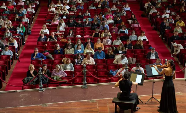 Violinist Hyunjin Cho and cellist Efstratia Chaloulakou perform for students studying with music at Concertgebouw in Amsterdam, Netherlands, on March 5, 2026. (AP Photo/Peter Dejong)