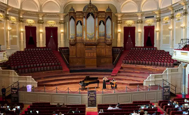 Students use by their laptops while studying with music at Concertgebouw in Amsterdam, Netherlands, on March 5, 2026. (AP Photo/Peter Dejong)