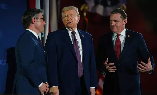 President Donald Trump talks with House Speaker Mike Johnson of La., and Rep. Richard Hudson, R-N.C., chair of the Naational Republican Congressional Committee (NRCC), at the annual fundraising dinner, Wednesday, March 25, 2026, at Union Station in Washington. (AP Photo/Julia Demaree Nikhinson)