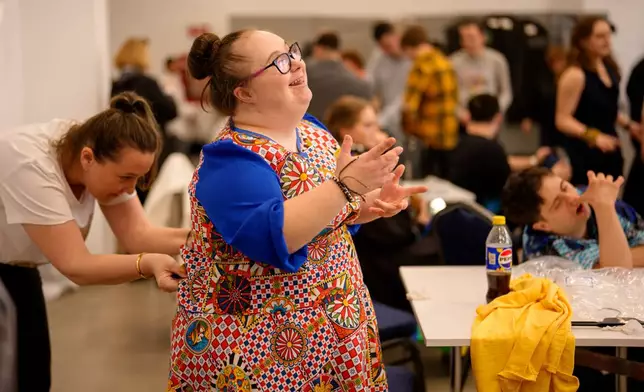 Alexandra Racatej tries on her outfit before the SEEN Anonymous Seamstresses Gala, an event organised by the Down Plus Bucharest, an NGO supporting youngsters with Down Syndrome and other intellectual disabilities, in Bucharest, Romania, Wednesday, March 18, 2026, ahead of the World Down Syndrome Day, on March 21. (AP Photo/Andreea Alexandru)