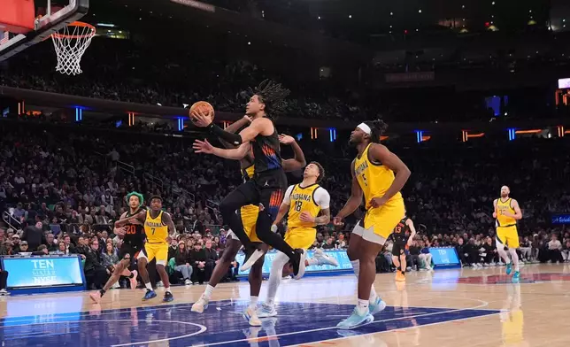 New York Knicks' Pacome Dadiet (4) Indiana Pacers' Jalen Slawson (18) during the second half of an NBA basketball game Tuesday, March 17, 2026, in New York. (AP Photo/Frank Franklin II)