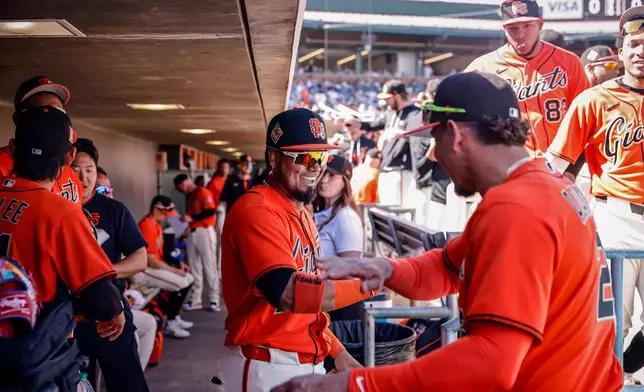 Luis Arraez (1) and Willy Adames (2) hype each other up before their spring training game between the San Francisco Giants and the Chicago Cubs in Scottsdale, Ariz., on Sunday, Feb. 22, 2026. (Carlos Avila Gonzalez/San Francisco Chronicle via AP)