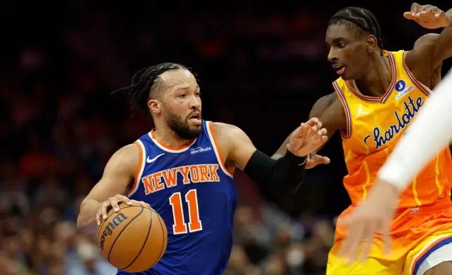 New York Knicks guard Jalen Brunson (11) drives against Charlotte Hornets forward Moussa Diabate, right, during the first half of an NBA basketball game in Charlotte, N.C., Thursday, March 26, 2026. (AP Photo/Nell Redmond)