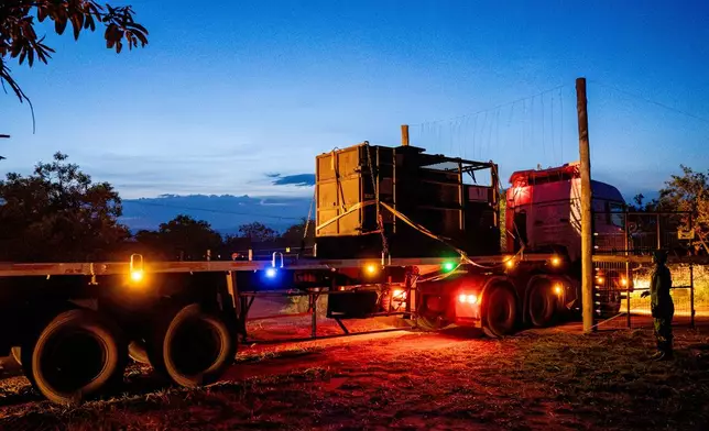 A truck carrying a rhinoceros in a transportation crate arrives at Kidepo Valley National Park in north-eastern Uganda, Tuesday, March 17, 2026. (AP Photo/Moses Dipak)