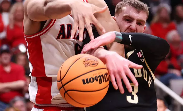 Arizona guard Brayden Burries, left, works for a rebound against Purdue guard Braden Smith during the second half in the Elite Eight of the NCAA college basketball tournament, Saturday, March 28, 2026, in San Jose, Calif. (AP Photo/Kelley L Cox)