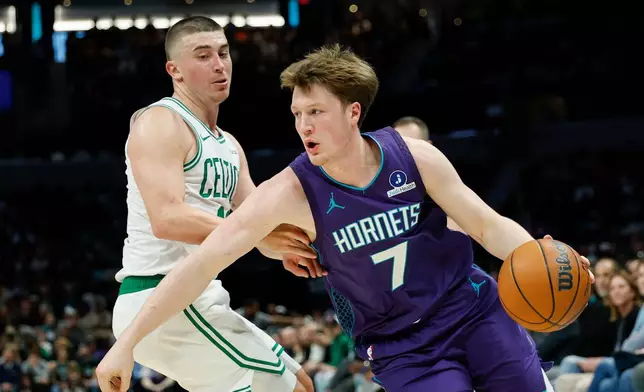 Charlotte Hornets guard Kon Knueppel (7) drives against Boston Celtics guard Payton Pritchard during the first half of an NBA basketball game in Charlotte, N.C., Sunday, March 29, 2026. (AP Photo/Nell Redmond)
