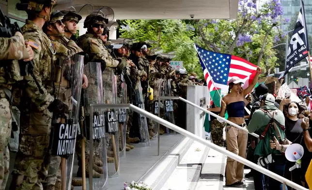 FILE - Protesters stand off against California National Guard soldiers at the Federal Building in downtown Los Angeles, during a "No Kings" protest, June 14, 2025. (AP Photo/Richard Vogel, File)