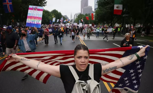 FILE - Demonstrators march down Benjamin Franklin Parkway during the "No Kings" protest, June 14, 2025, in Philadelphia. (AP Photo/Yuki Iwamura, File)