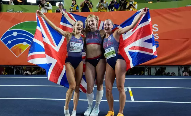 Gold medalists Georgia Hunter Bell, Molly Caudery and Keely Hodgkinson, all three of of Britain, pose together after winning their events at the World Athletics Indoor Championships in Torun, Poland, Sunday, March 22, 2026. (AP Photo/Matthias Schrader)