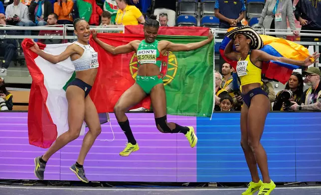 Silver medalist Larissa Iapichino, of Italy, gold medalist Agate de Sousa, of Portugal, and bronze medalist Natalia Linares, of Colombia, pose after the women's long jump final at the World Athletics Indoor Championships in Torun, Poland, Sunday, March 22, 2026. (AP Photo/Matthias Schrader)