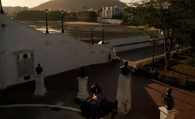 A woman poses for photos marking her quinceañera, or 15th birthday, in the Casco Viejo, the historic district of Panama City, Wednesday, March 11, 2026. (AP Photo/Matias Delacroix)