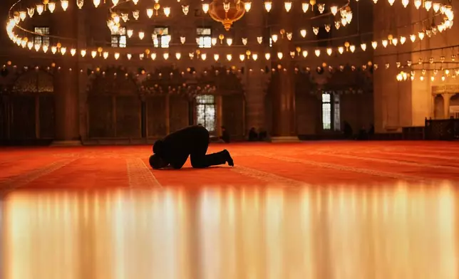 A worshipper prays at Suleymaniye mosque during the Muslim holy fasting month of Ramadan, in Istanbul, Turkey, Thursday, March 12, 2026. (AP Photo/Francisco Seco)
