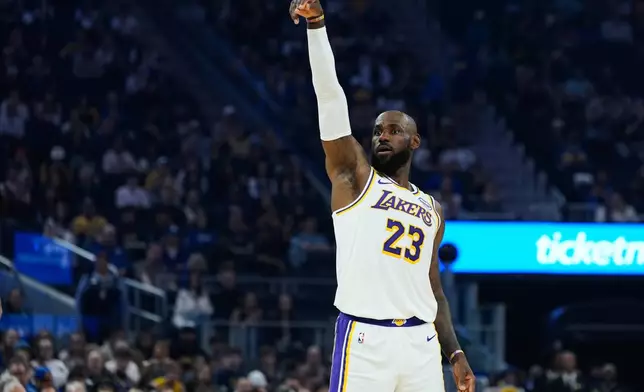 Los Angeles Lakers forward LeBron James (23) watches as he makes a 3-point basket during the first half of an NBA basketball game against the Golden State Warriors, Saturday, Feb. 28, 2026, in San Francisco. (AP Photo/Godofredo A. Vásquez)