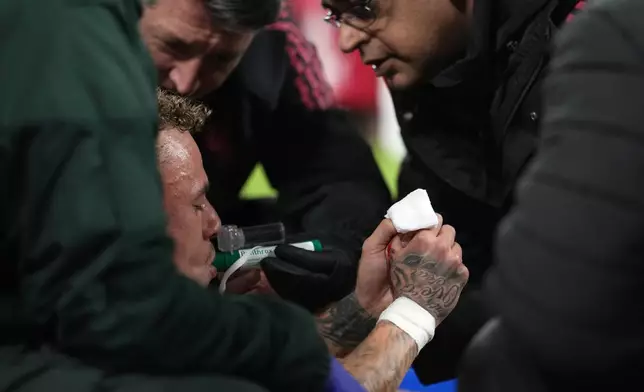 Galatasaray's Noa Lang receives medical treatment after sustaining an injury during the second leg of the Champions League round of 16 soccer match between Liverpool and Galatasaray, in Liverpool, England, Wednesday, March 18, 2026. (AP Photo/Jon Super)