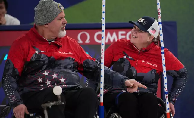 Stephen Emt of the United States gestures with Laura Dwyer as they compete against Estonia in a wheelchair curling mixed doubles round robin session at the 2026 Winter Paralympics, in Cortina d'Ampezzo, Italy, Thursday, March 5, 2026. (AP Photo/Emilio Morenatti)