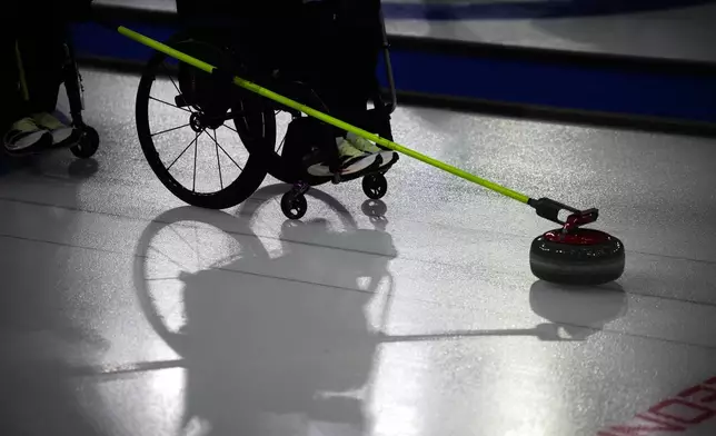 Joanna Butterfield, of Britain, competes against South Korea in a wheelchair curling mixed doubles round robin session at the 2026 Winter Paralympics, in Cortina d'Ampezzo, Italy, Thursday, March 5, 2026. (AP Photo/Emilio Morenatti)