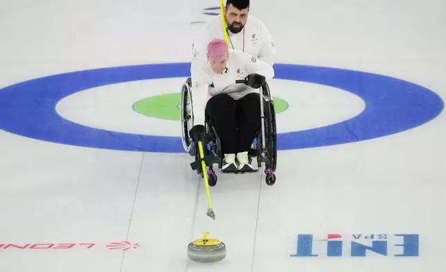 Joanna Butterfield and Jason Kean competes against Latvia during a wheelchair curling mixed doubles at the 2026 Winter Paralympics, in Cortina d'Ampezzo, Italy, Thursday, March 5, 2026. (AP Photo/Evgeniy Maloletka)