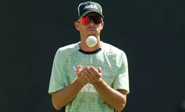 New Zealand's captain Mitchell Santner toss a ball during a practice session ahead of the T20 World Cup cricket final match against India in Ahmedabad, India, Saturday, March 7, 2026. (AP Photo/Ajit Solanki)