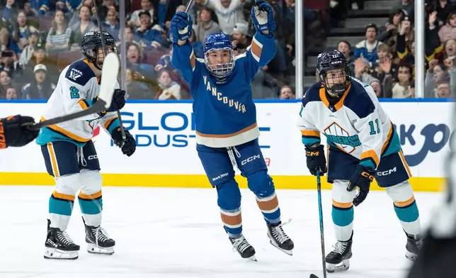 Vancouver Goldeneyes' Anna Segedi (51) celebrates her goal as New York Sirens' Nicole Vallario (11) watches the goal during the first period of a PWHL hockey game in Vancouver, on Wednesday, March 18, 2026. (Ethan Cairns/The Canadian Press via AP)