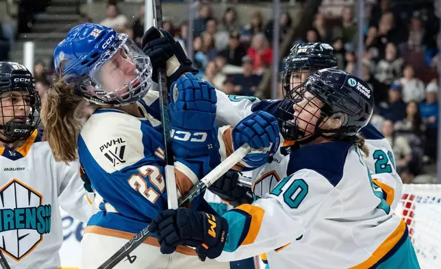 New York Sirens' Sarah Fillier (10) hits Vancouver Goldeneyes' Abby Boreen (22) during the third period of a PWHL hockey game in Vancouver, British Columbia, Wednesday, March 18, 2026. (Ethan Cairns/The Canadian Press via AP)