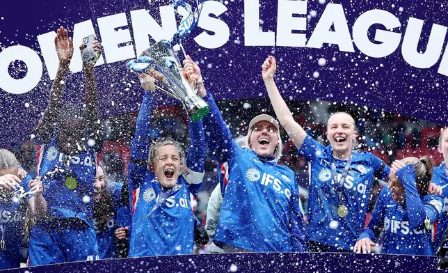 Chelsea's Millie Bright, centre right, and Erin Cuthbert, centre left, lift the trophy after winning the Women's League Cup final, in Bristol, England, Sunday, March 15, 2026. (Steve Paston/PA via AP)