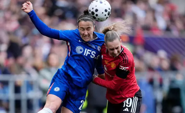 Chelsea's Lucy Bronze, left, and Manchester United's Ellen Wangerheim battle for the ball during the Women's League Cup final, in Bristol, England, Sunday, March 15, 2026. (Nick Potts/PA via AP)